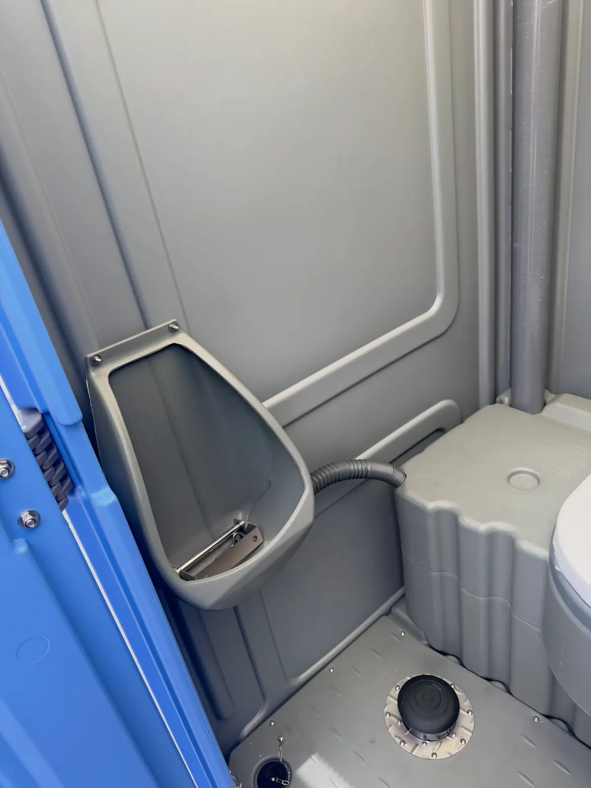 Urinal and seat in a portable toilet